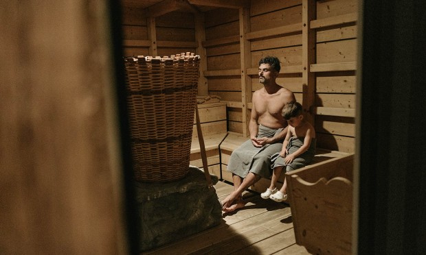 Father and son enjoy the family sauna together at the Feuerstein Nature Family Resort.