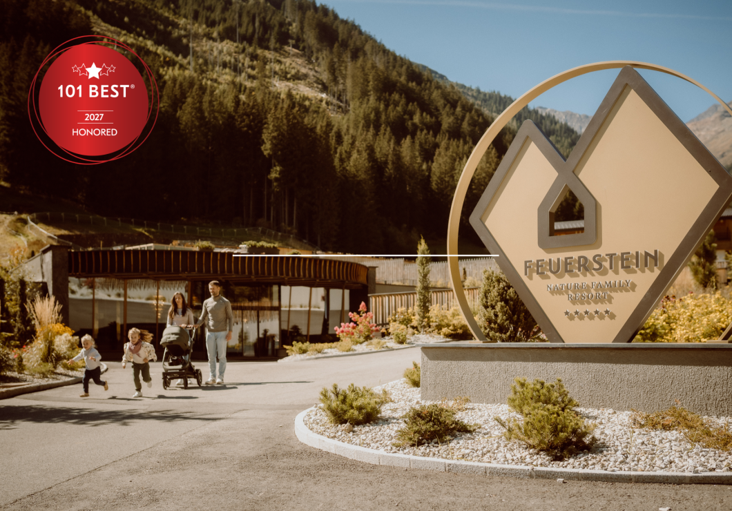 Family walks past the reception and the large Feuerstein logo.
