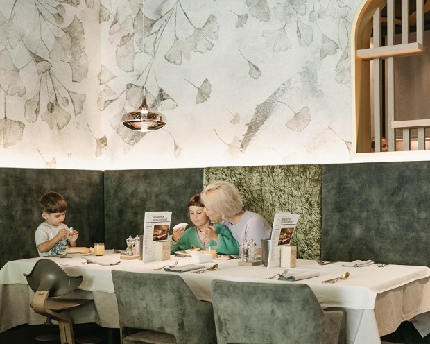 A family is having breakfast at a children's hotel in South Tyrol.