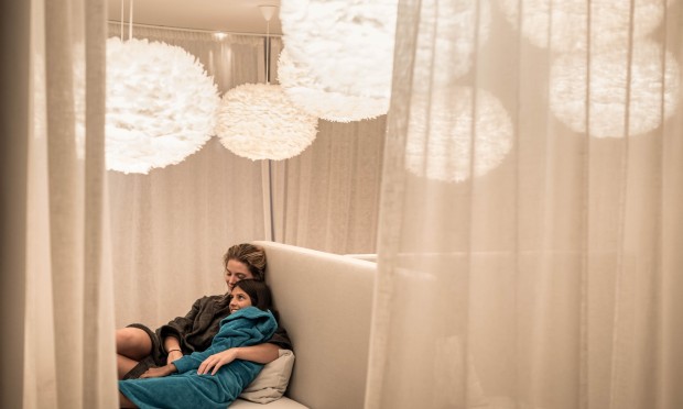 Mother and daughter enjoy quality time together and cuddle up in the family relaxation room at the Feuerstein Nature Family Resort - Mountain Spa.