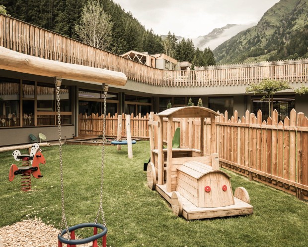 The new outdoor area of the Baby & Mini Room with swings, nest swings, wooden toy train, rocking horses and much more.