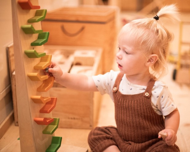 Bambino piccolo gioca con giocattoli di legno