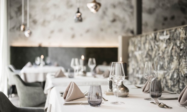 Un ristorante elegante con tavoli apparecchiati e decorazioni in bianco e nero
