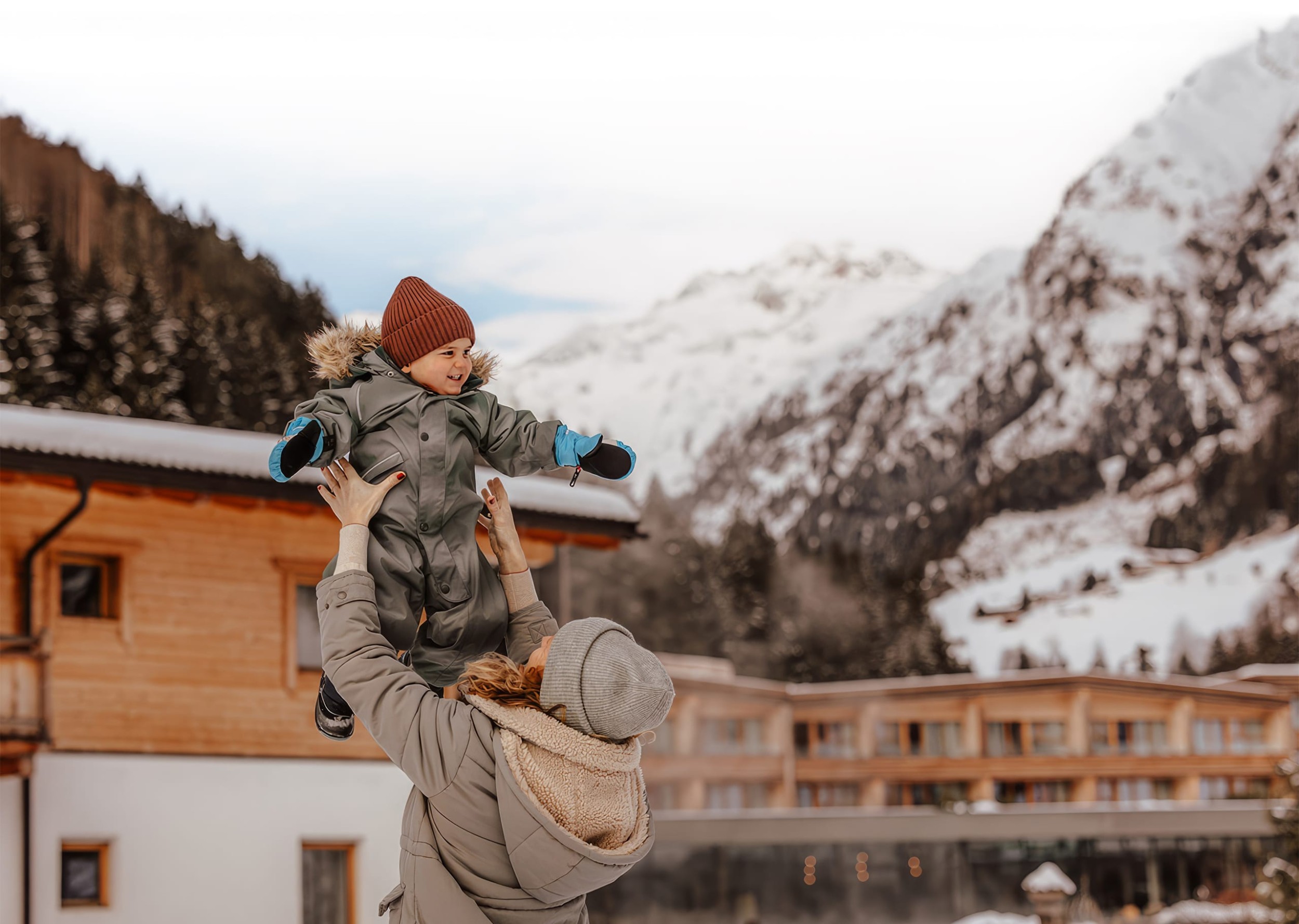 Mother holds child up in the air