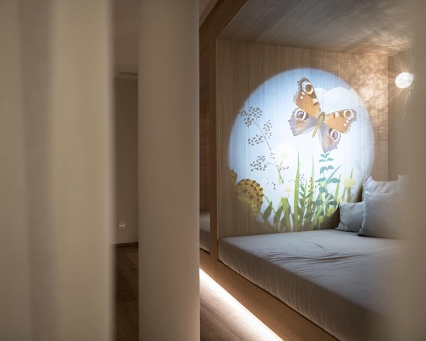 Relaxation area for children with cushions and projector for entertainment