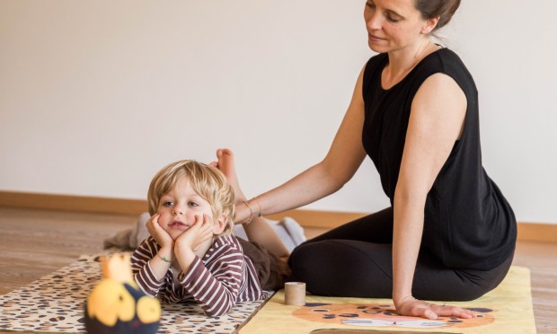 A mother practices various exercises on her child during the Family Relax session, and the child enjoys it.