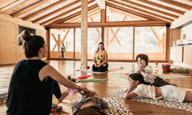 A mother and her children practice various massage techniques during the Family Relax in the Yoga Loft.