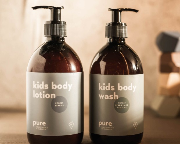 Two bottles of Pure Kids cosmetics from Feuerstein: Kids Body Wash and Kids Body Lotion.