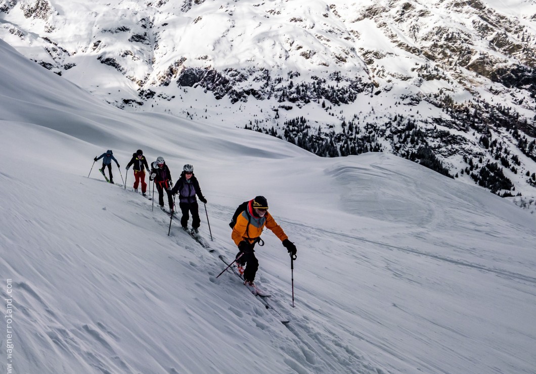 Gruppo di sci alpinisti che salgono il pendio innevato vicino al Feuerstein.