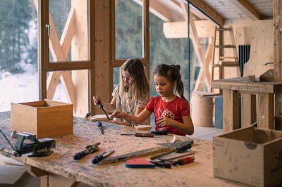 Kids working with wood at the wood workshop of the Feuerstein family hotel in South Tyrol