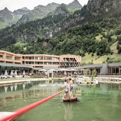 2 Jungs ziehen sich auf dem Floß über den Teich