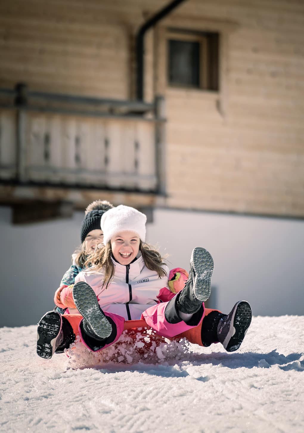 Children toboggan down the hill