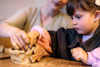 Little girl plays with clay
