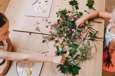 Children play with herbs on a table