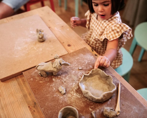 Girl plays with clay