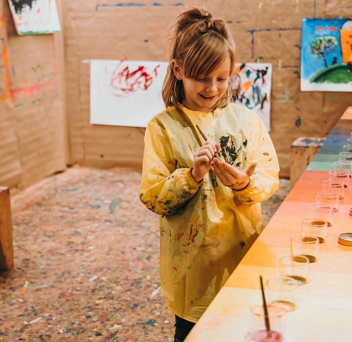 Girl paints in the painting studio