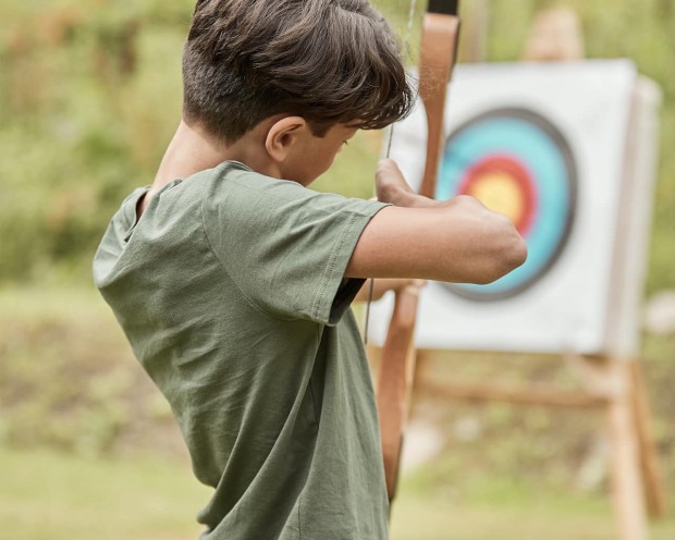 Un adolescente pratica il tiro con l'arco