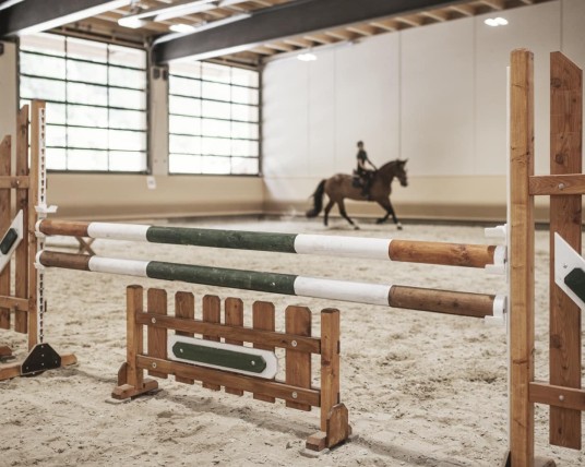 Riding in the indoor riding arena at the Feuerstein family hotel, the ideal place for a family holiday in the mountains