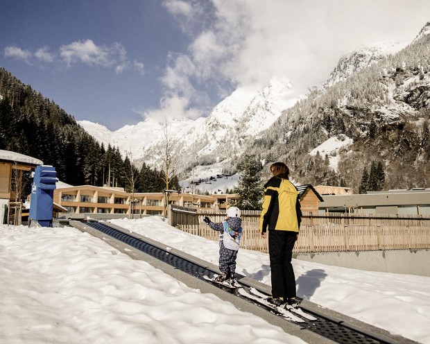 First attempts at skiing in the garden of the Feuerstein family hotel, the ideal place for a family holiday in the mountains